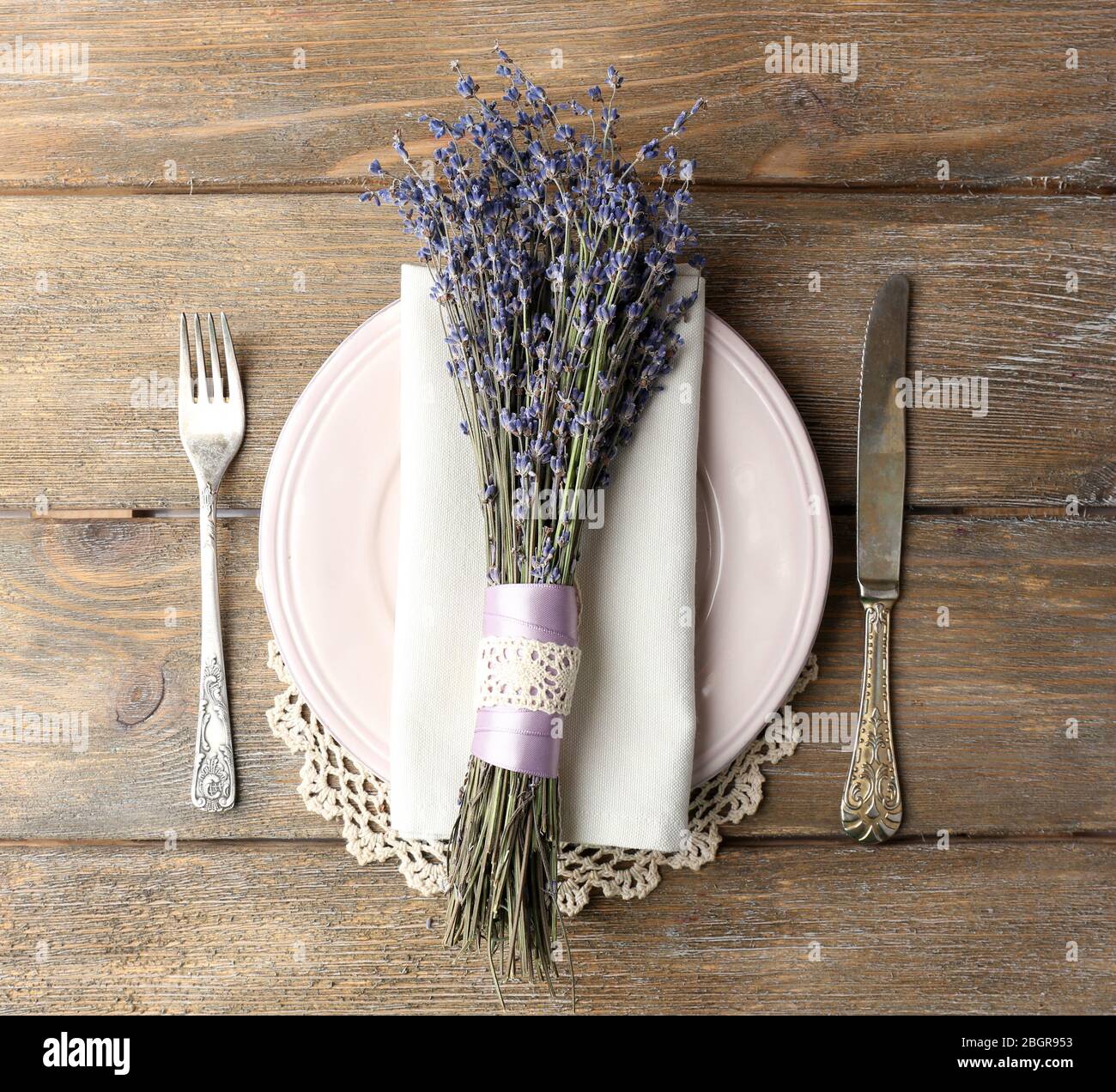 Tavolo da pranzo impostazione con fiori di lavanda sul tavolo di legno sfondo Foto Stock