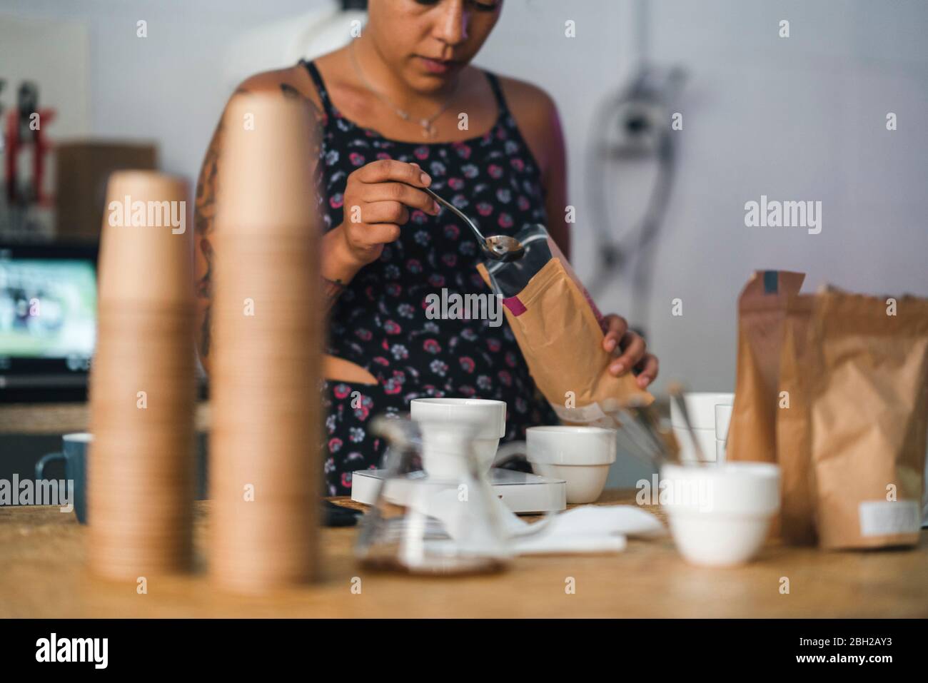Donna che lavora in una torrefazione del caffè che prepara il caffè Foto Stock