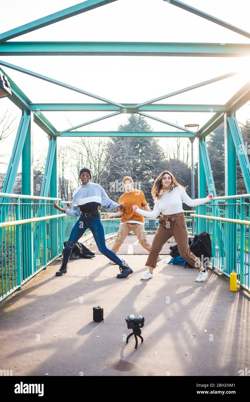 Giovani ballerini che provano in un parco di skate, facendo un video Foto Stock