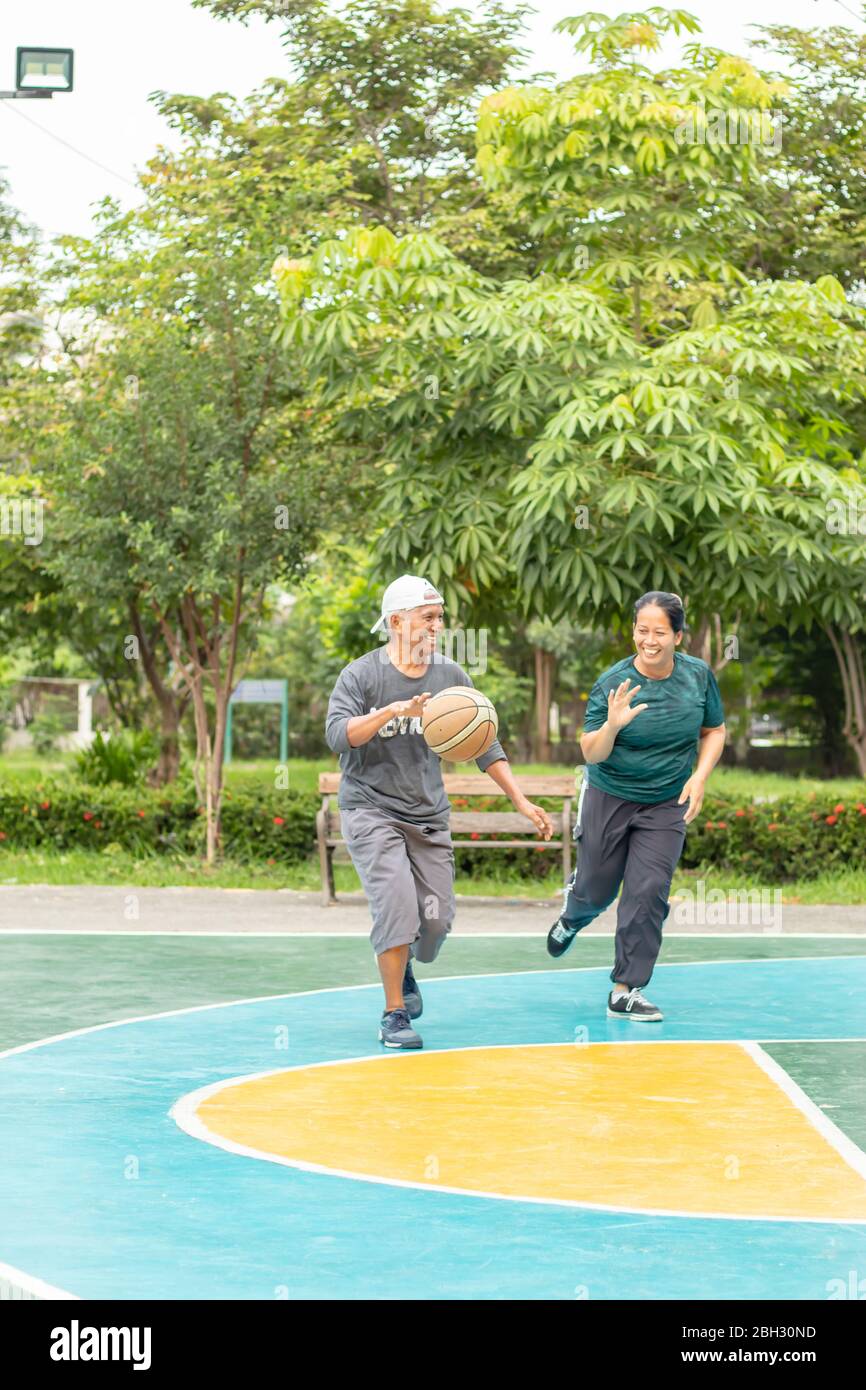 Vecchio uomo e donna a giocare a basket al mattino così felicemente al BangYai Park Nonthaburi in Thailandia. 22 agosto 2018 Foto Stock