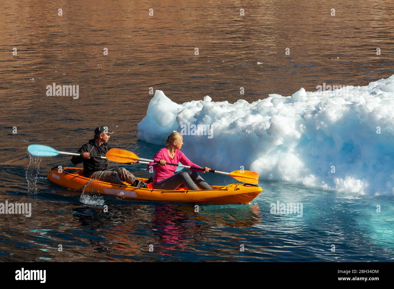 Un paio di kayak intorno a un iceberg in Groenlandia durante l'estate Foto Stock