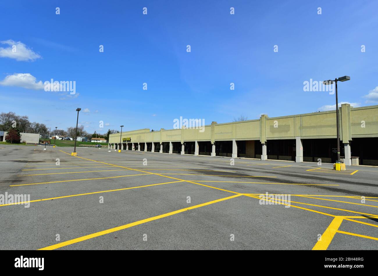Streamwood, Illinois, Stati Uniti. Un parcheggio vuoto offre un aspetto fantasma città-come ad un centro commerciale strip durante la pandemia coronavirus. Foto Stock