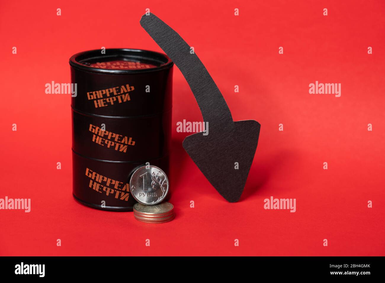 Barile nero con una moneta rubla e una freccia giù su sfondo rosso. Il prezzo al barile del petrolio scende sotto grafico. Andamento del mercato petrolifero. Infografica sul petrolio. Foto Stock