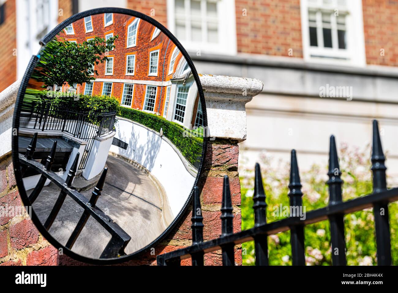 Londra, UK quartiere di Kensington con specchio closeup riflessione del vialetto su vicolo strada mews con architettura vuota strada e nessuno Foto Stock