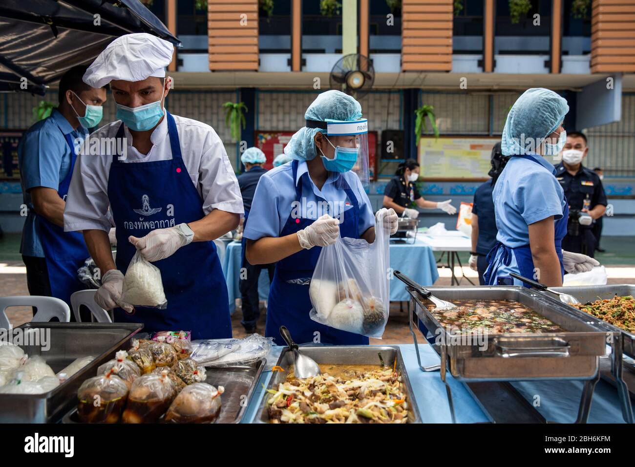 Bangkok, Thailandia. 24 Aprile 2020. L'aeronautica tailandese parte fuori i pasti liberi per contribuire a combattere la perdita di reddito dovuto COVID-19 alla scuola di Wat Don Muang a Bangkok, Thailandia. 300 famiglie hanno accettato il cibo gratuito, con un'alimentazione stimata di 1500 persone sulla base della dimensione media della famiglia. Il cibo è stato agevolato dalla Thai Airforce per garantire adeguate misure di distanza sociale. Credit: Andre Malerba/ZUMA Wire/Alamy Live News Foto Stock