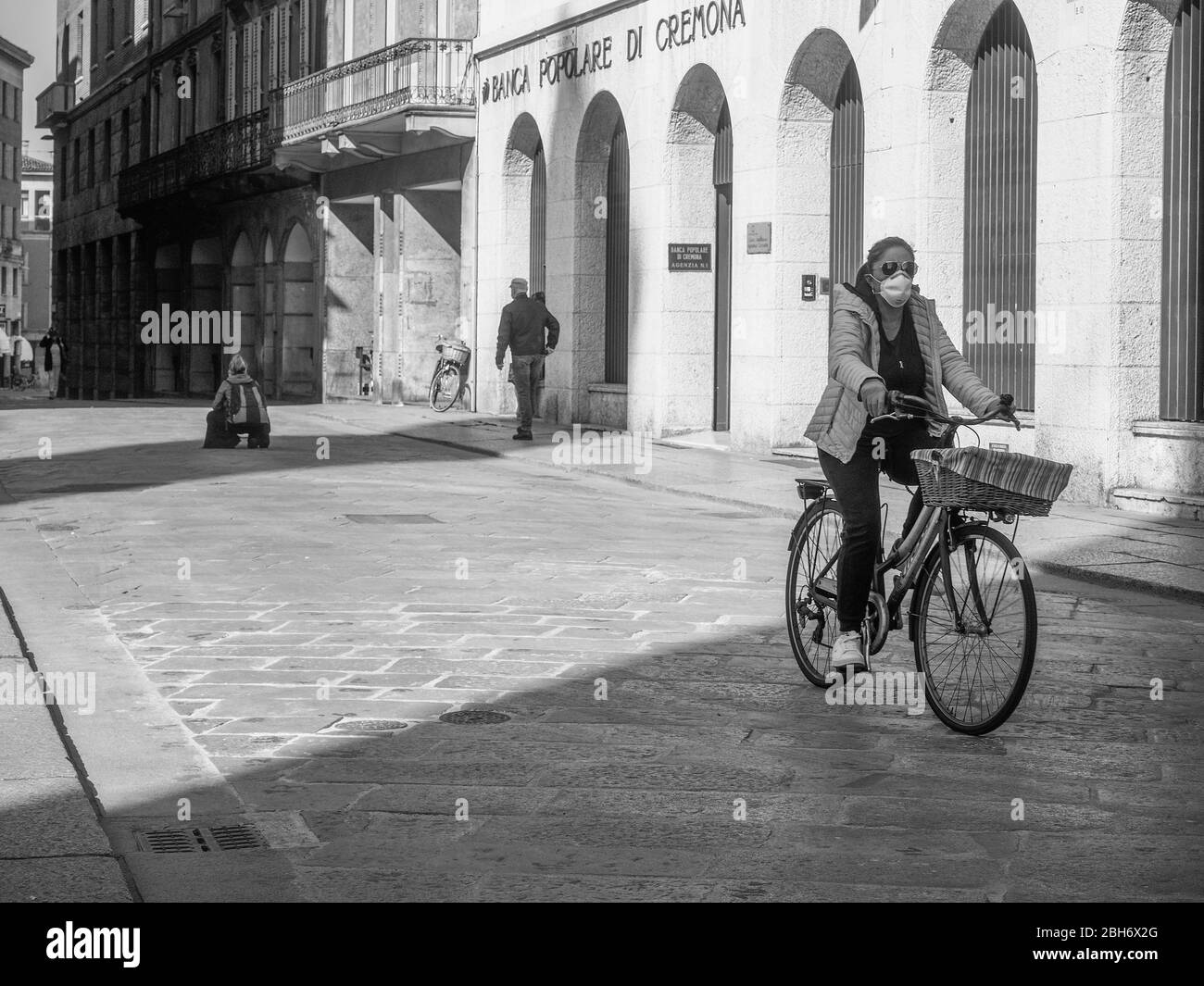 Cremona, Lombardia, Italia - 24 Aprile 20 2020 - persone a piedi, in bicicletta e in dogwalking in centro, vita quotidiana della città durante il coronavirus città di blocco Foto Stock