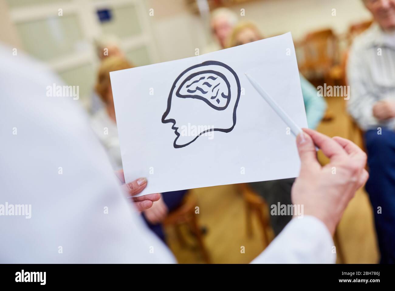 Medico femminile con un disegno del cervello dà una lezione sulla demenza e la memoria Foto Stock