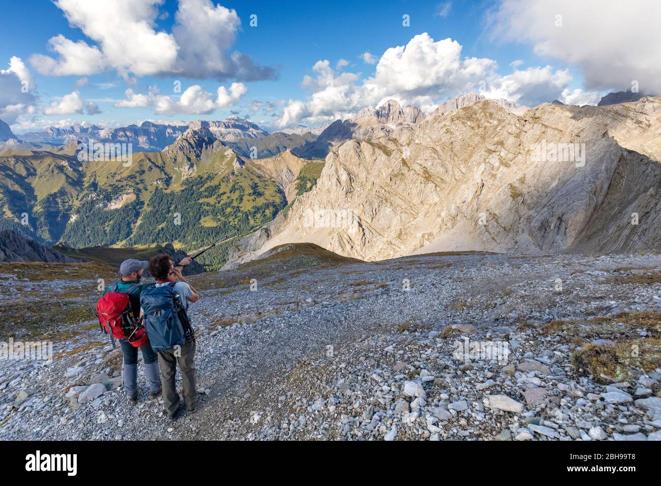 Due escursionisti osservano il gruppo Sella e il gruppo Marmolada dell'Alto Sentiero Bepi Zac, il crinale Costabella, il gruppo Marmolada, le Dolomiti, la Val di Fassa, la provincia di Trento, il Trentino-Alto Adige, Italia Foto Stock