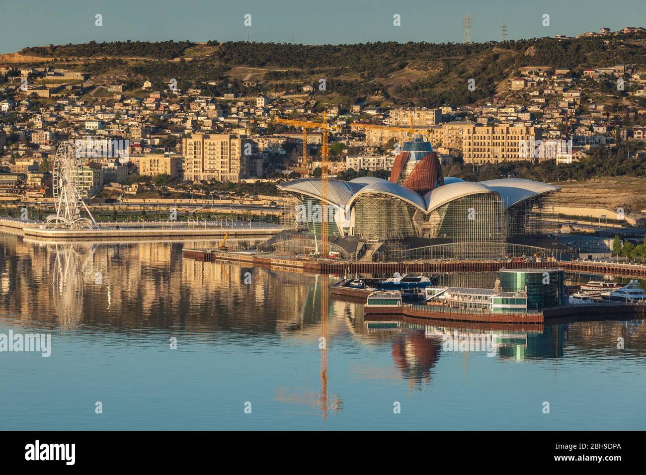 Azerbaigian, Baku, ad alto angolo di visione del waterfront Death Star Hotel in costruzione, alba Foto Stock