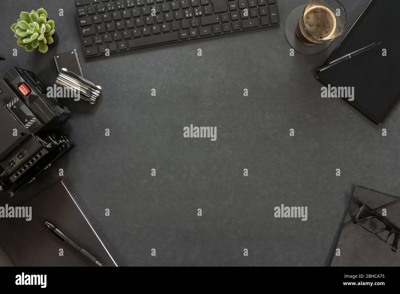 Vista dall'alto della tastiera e del diario con attrezzatura fotografica sul tavolo Foto Stock