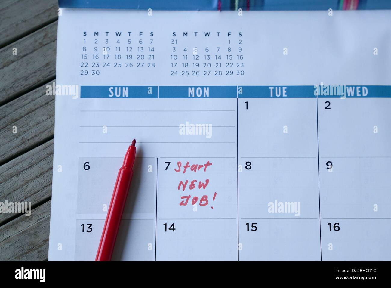 Avviare nuove parole di lavoro scritte sul calendario della tabella con un indicatore rosso. Concetto di occupazione o di carriera. Foto Stock