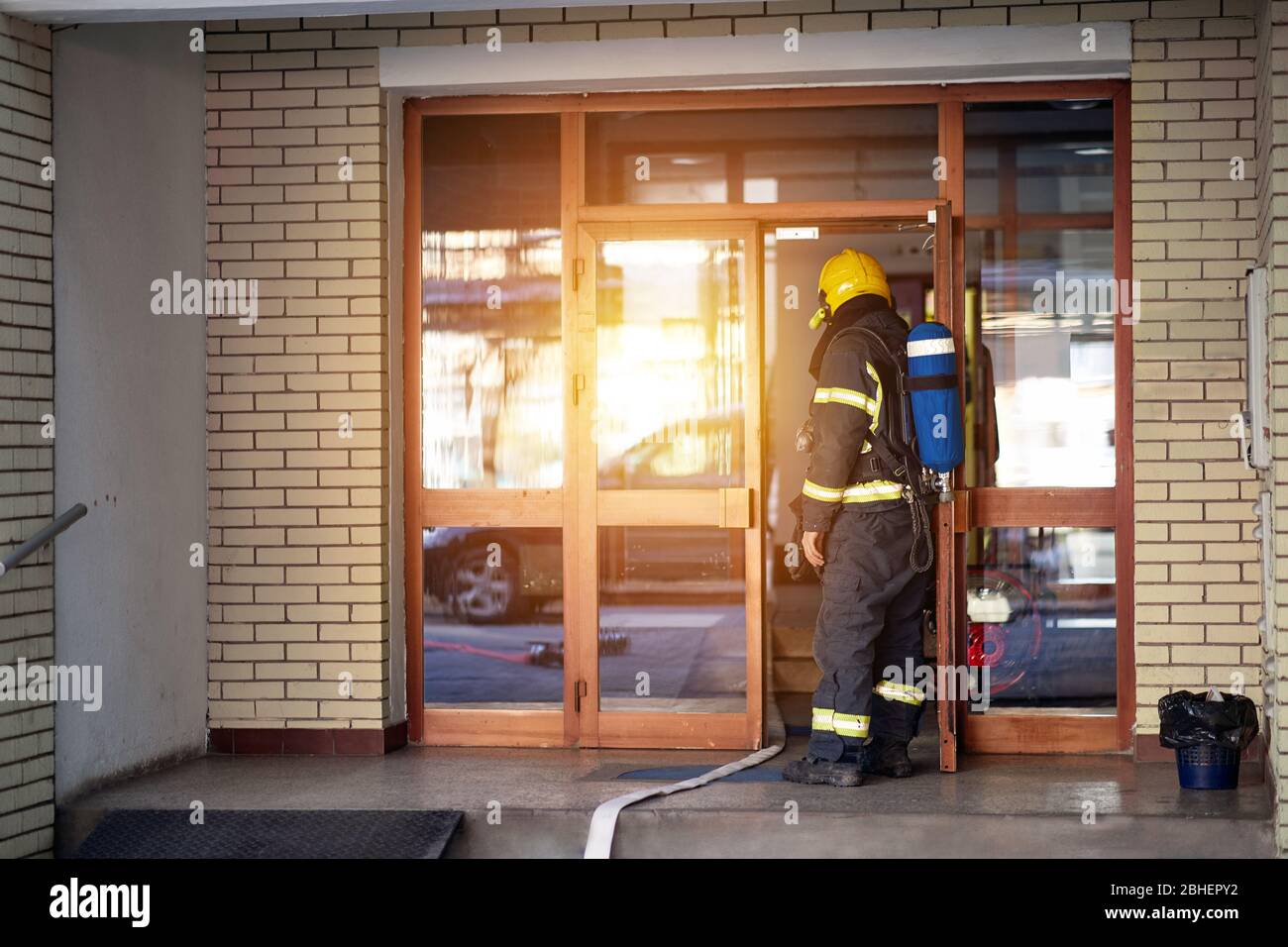 Vigili del fuoco sul job.Fireman in uniforme e casco al fuoco domestico in un edificio di appartamenti. Foto Stock