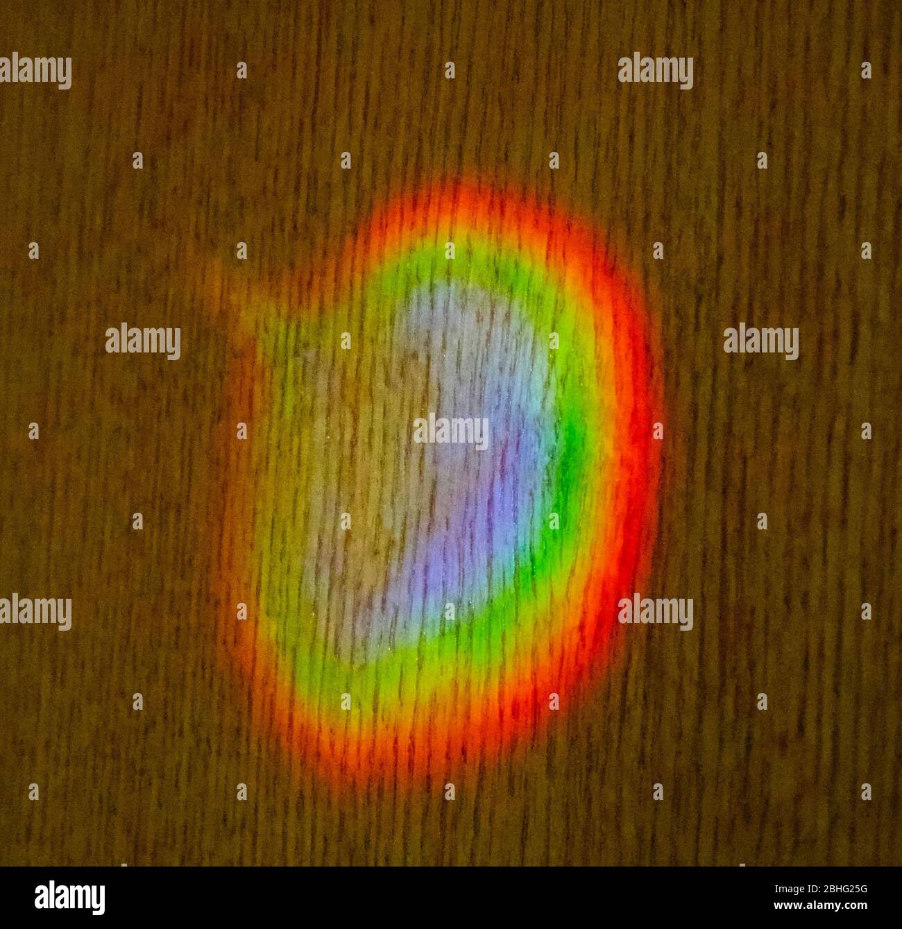 Spettro di colori da Prism colato sul muro dal sole in serata Foto Stock