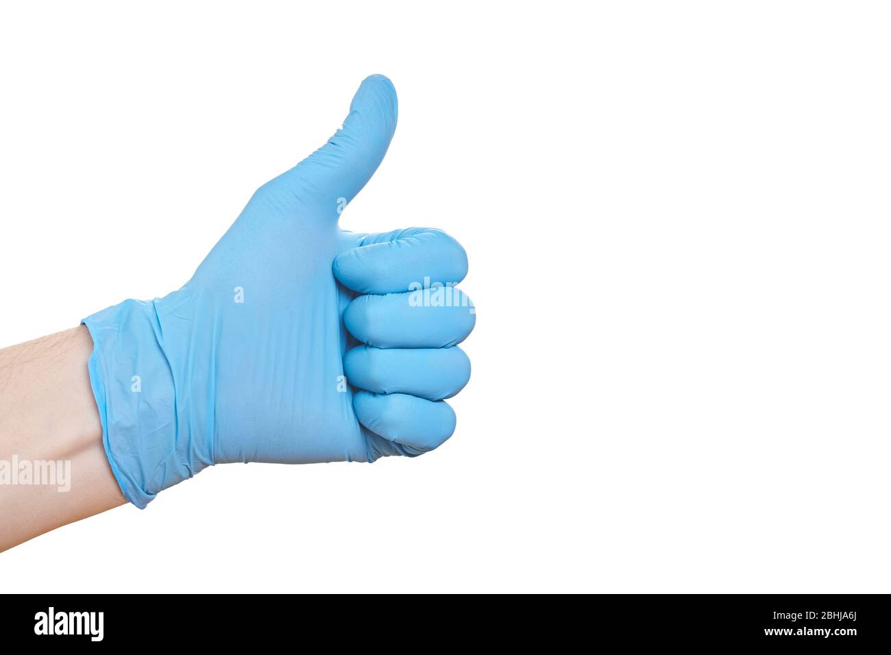 Mano in guanto medico blu mostra pollici in su Foto Stock