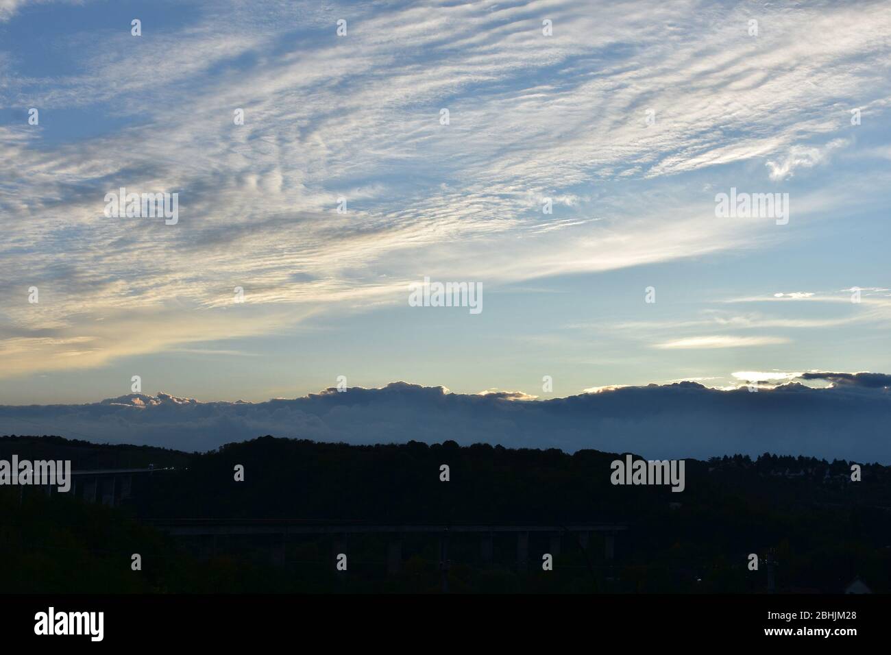 In mezzo alla natura ci sono due viadotti, e sopra il cielo sono striate, nubi minuscole Foto Stock