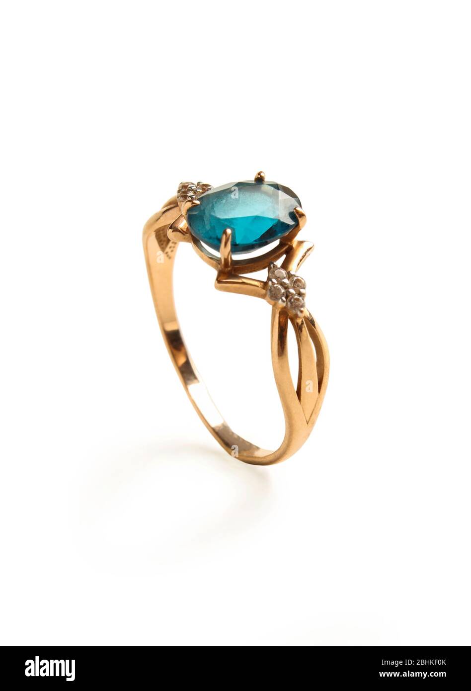 Anello dorato con topazio blu isolato su bianco Foto Stock