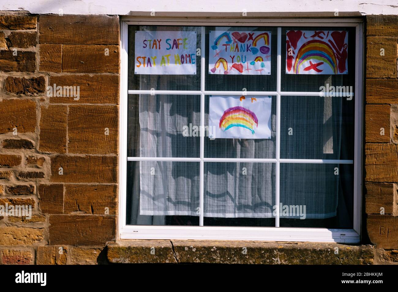 Dipinti arcobaleni e grazie segni in una finestra a Bugbrooke, Northamptonshire Foto Stock