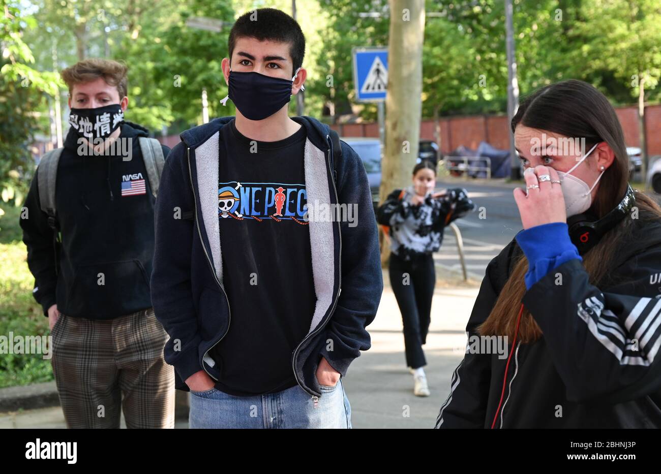 27 aprile 2020, Hessen, Francoforte sul meno: Gli studenti della scuola superiore Q2 della palestra Heinrich von Gagern indossano maschere facciali quando entrano nell'edificio scolastico. Sei settimane dopo la chiusura della scuola correlata alla corona in Assia, le lezioni riprendono. Inizialmente, circa 110,000 studenti delle classi dell'ultimo anno torneranno alle loro classi. Foto: Arne Dedert/dpa Foto Stock