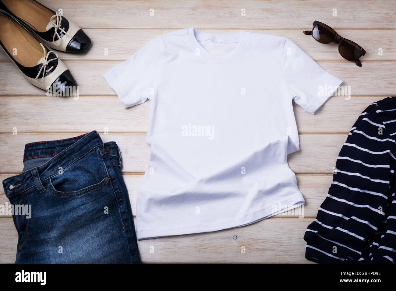 T-shirt in cotone bianco da donna in stile francese con t-shirt e jeans a righe breton. Design tee stampa presentazione mock up Foto Stock