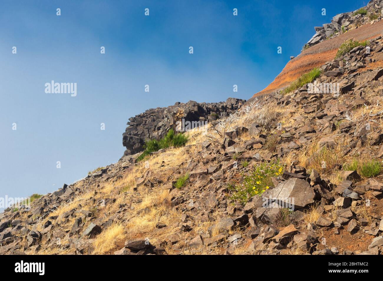 Il pendio della montagna con una ghiaione rocciosa contro il cielo blu. Foto Stock
