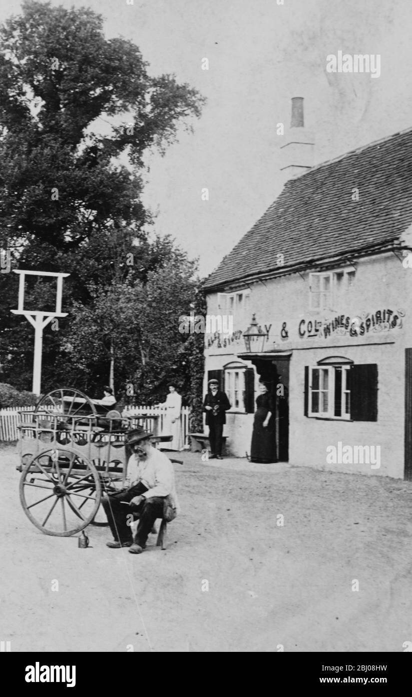 Un uomo con un piccolo carro fuori casa pubblica a Eversley - 1906 Foto Stock