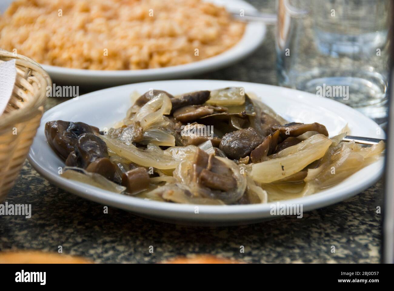 Funghi cucinati con aglio e cipolle serviti come parte di meze nel ristorante greco-cipriota nelle montagne nel sud di Cipro - Foto Stock
