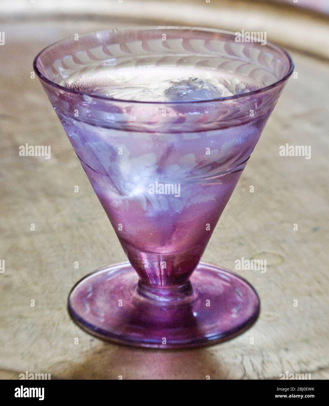 Piccolo vetro decorativo di vodka sulle rocce, su vassoio foglia d'oro - Foto Stock