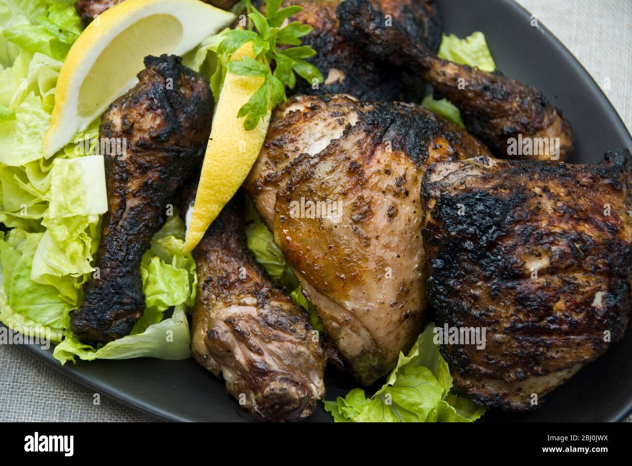 Zampe di pollo alla griglia sul plater con insalata all'aperto - Foto Stock
