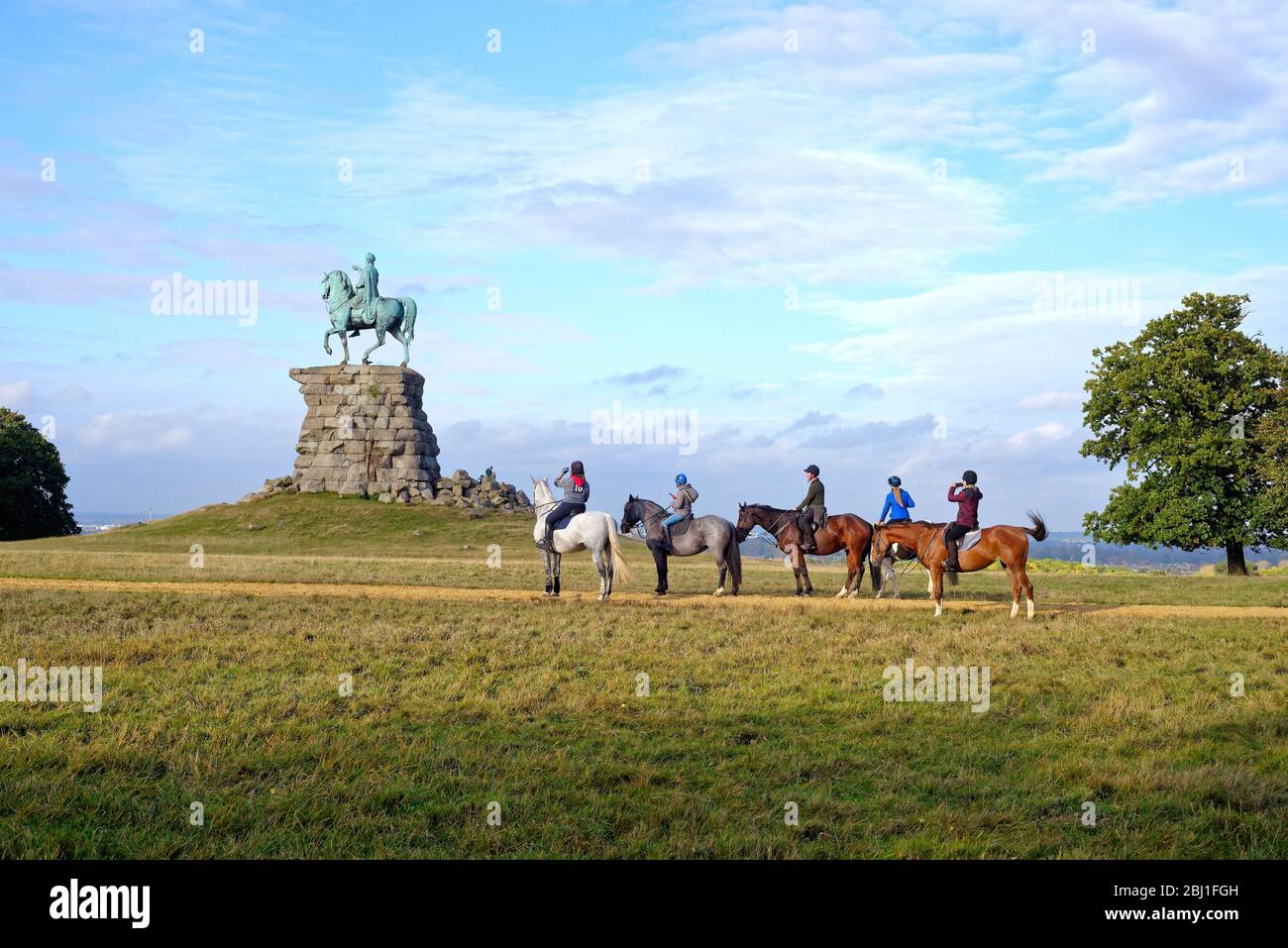 I cavalieri di cavallo si avvicinano alla statua equestre del Cavallo di rame di Re George Third, Snow Hill Windsor Great Park Berkshire Inghilterra Regno Unito Foto Stock