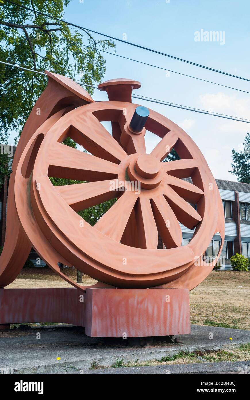 'Gateway', scultura di Fritz Church, è la grande ruota arancione sulla South Tacoma Way a Tacoma, Washington. Poggia su due punte ferroviarie stilizzate. Foto Stock