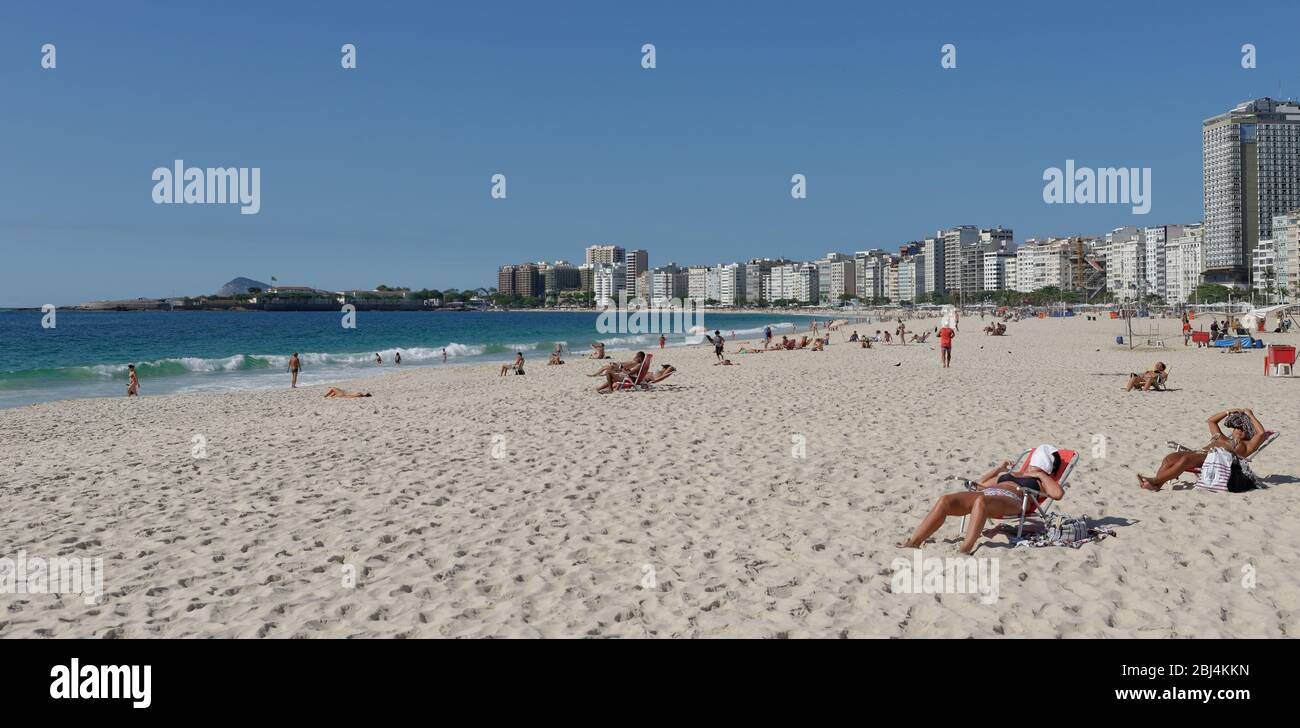 Attivita' e bagni di sole sulla spiaggia di Copacabana, Rio De Janeiro, Brasile con hotel sullo sfondo. Foto Stock