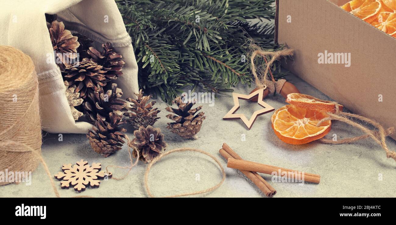 Zero sprechi e concetto di natale eco-friendly. Decorazioni naturali e rami di un albero di Natale a tavola. Foto Stock