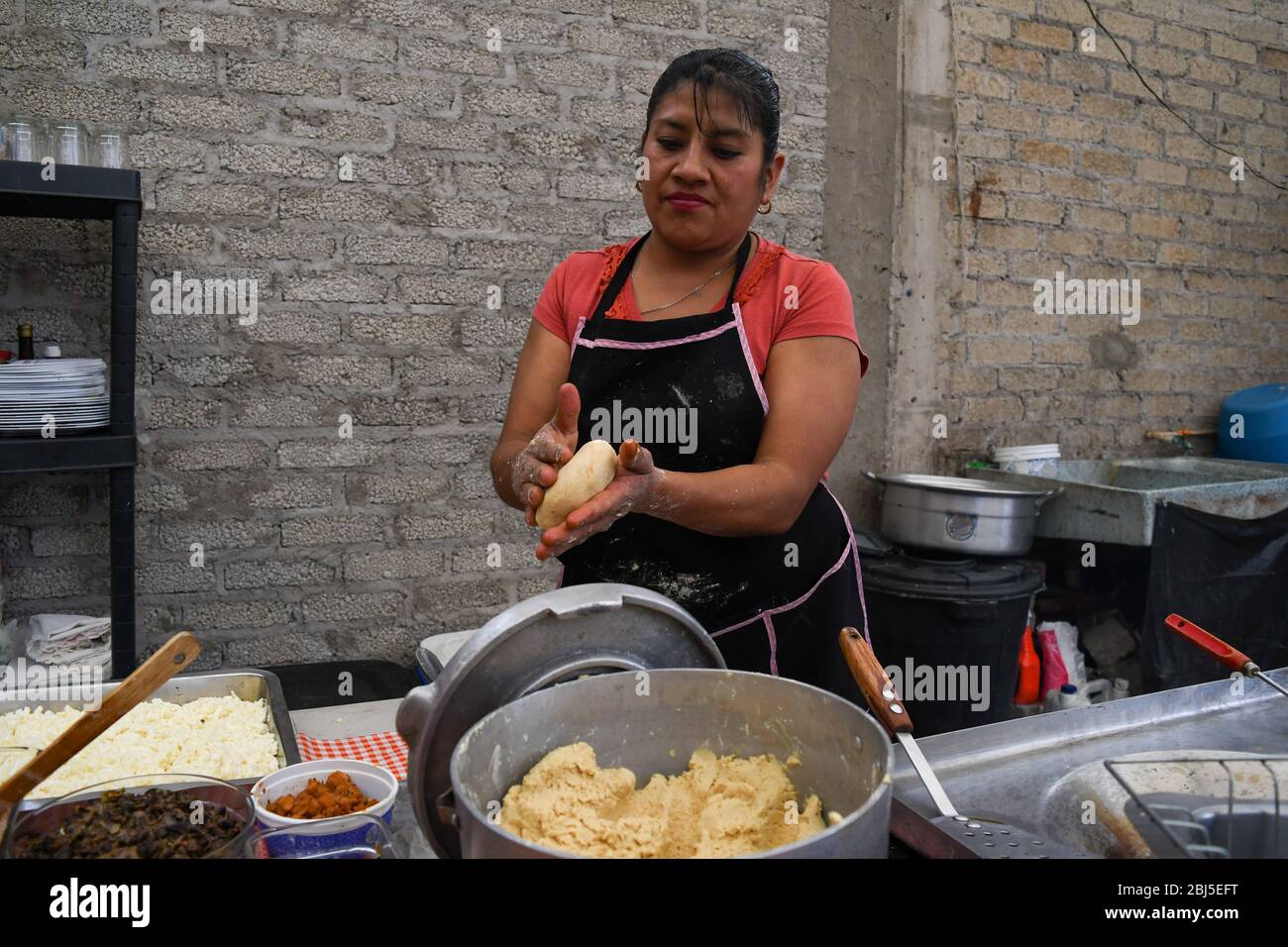 Vecchia donna che prepara un piatto tipico messicano Foto Stock