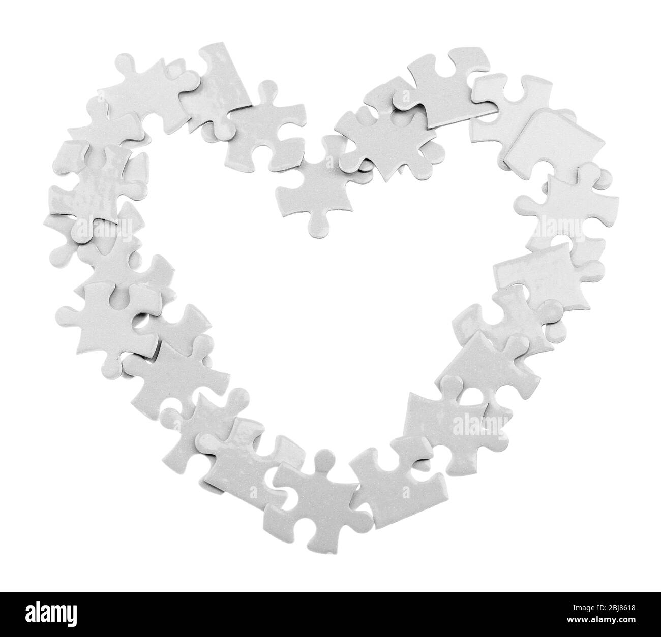 Puzzle forma cuore, isolato su bianco Foto Stock