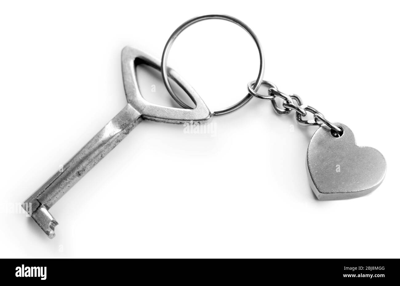 Chiave con cuore trinket, isolato su bianco Foto Stock