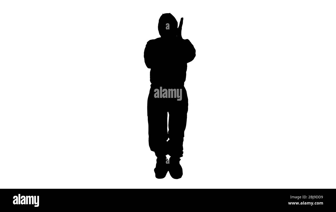 Silhouette uomo che indossa abbigliamento protettivo HAZMAT che mostra di indossare i guanti. Foto Stock