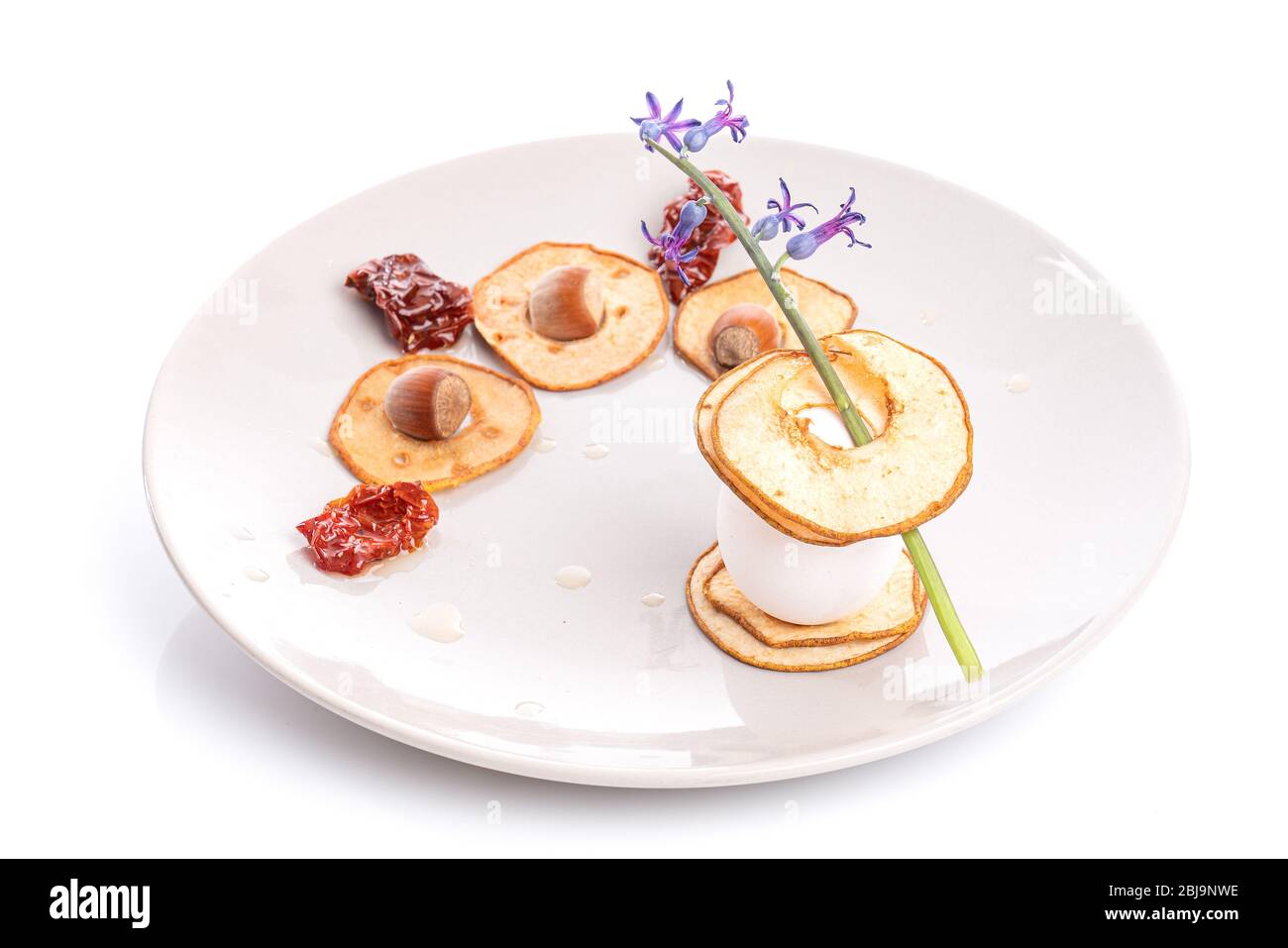 Piatto vegetariano con pera secca a fette con uova, pomodori secchi e nocciole. Foto Stock