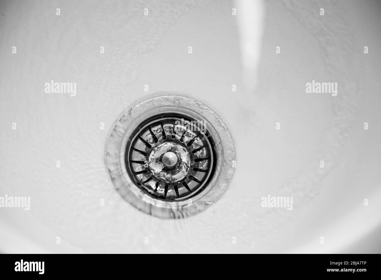 Acqua che scorre nello scarico del lavandino della cucina Foto Stock