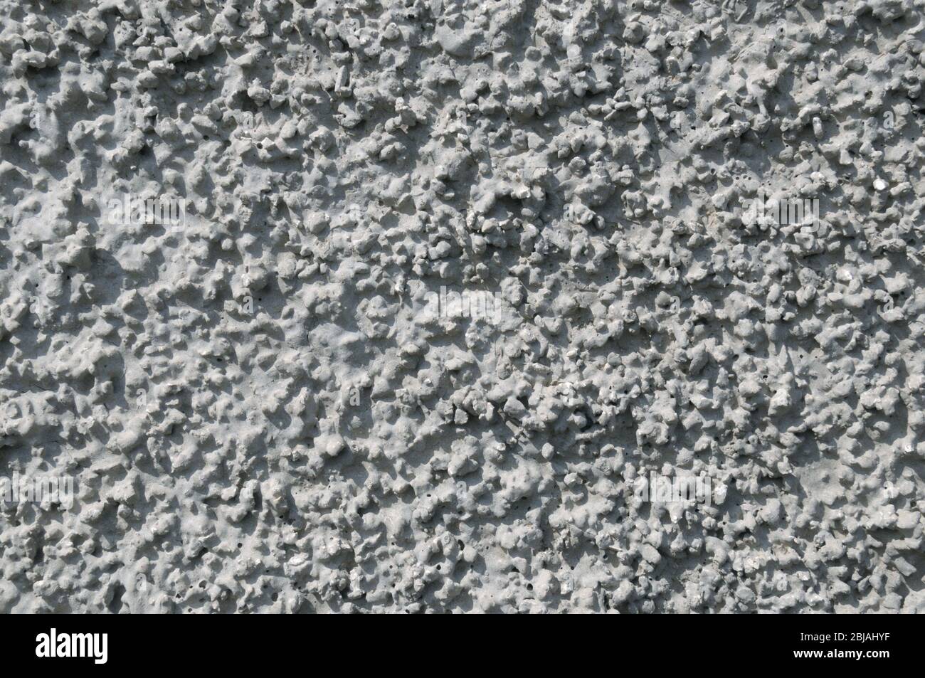 Intonaco di cemento su parete di calcestruzzo. Sfondo grigio. Foto Stock
