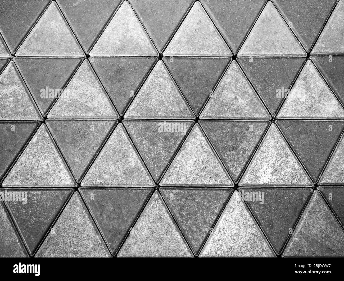 Pavimento in cemento grigio, sfondo a forma di triangolo. Cemento piastrelle di tessitura del pavimento. Foto Stock