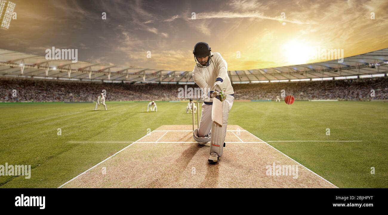 Giovane sportivo che batte nel campo di cricket Foto Stock