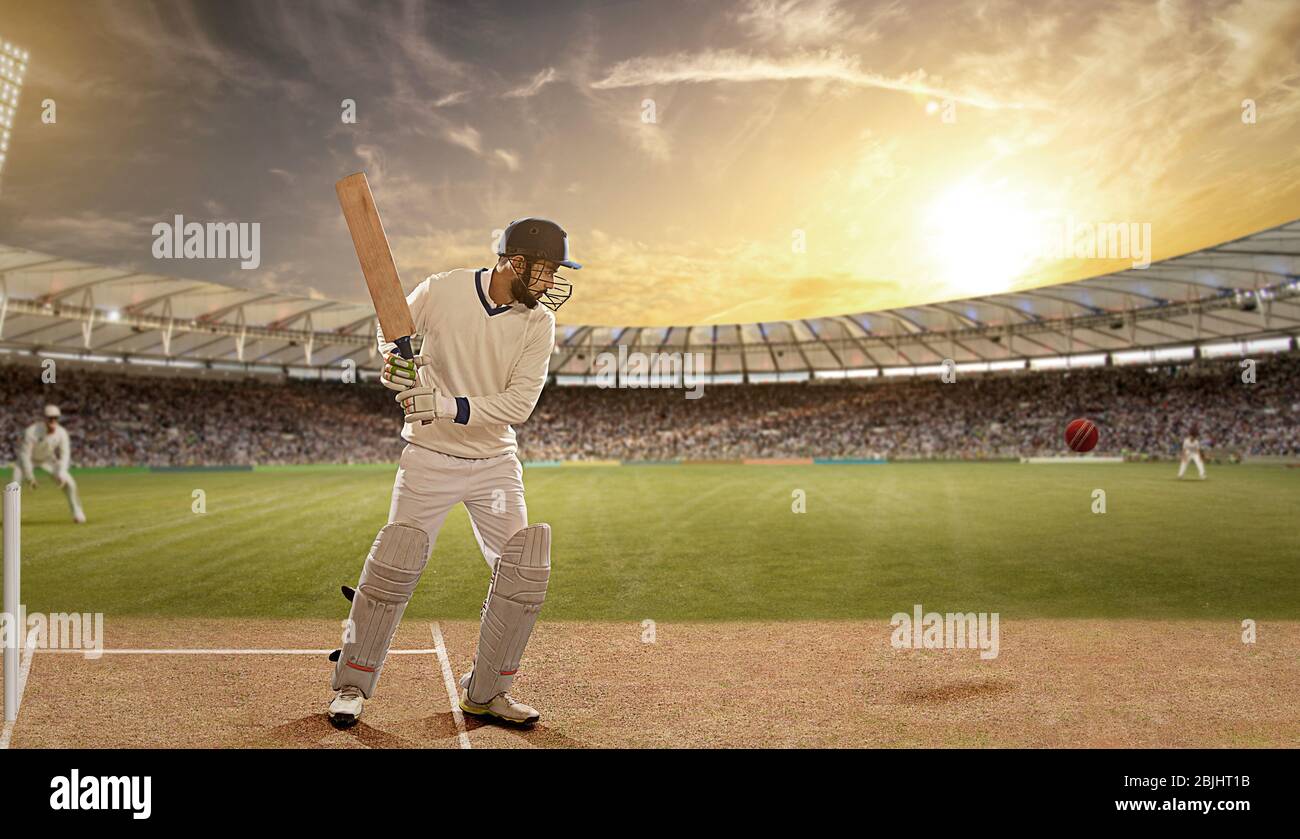 Battitore difende una palla durante una partita nello stadio Foto Stock