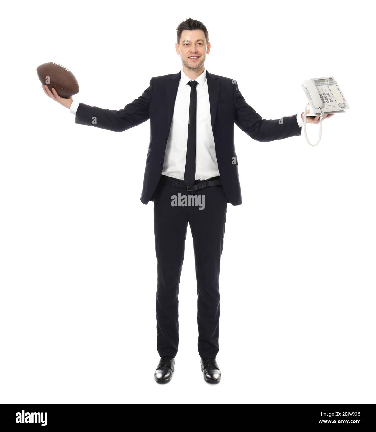 Uomo d'affari con palla di rugby e telefono su sfondo bianco Foto Stock