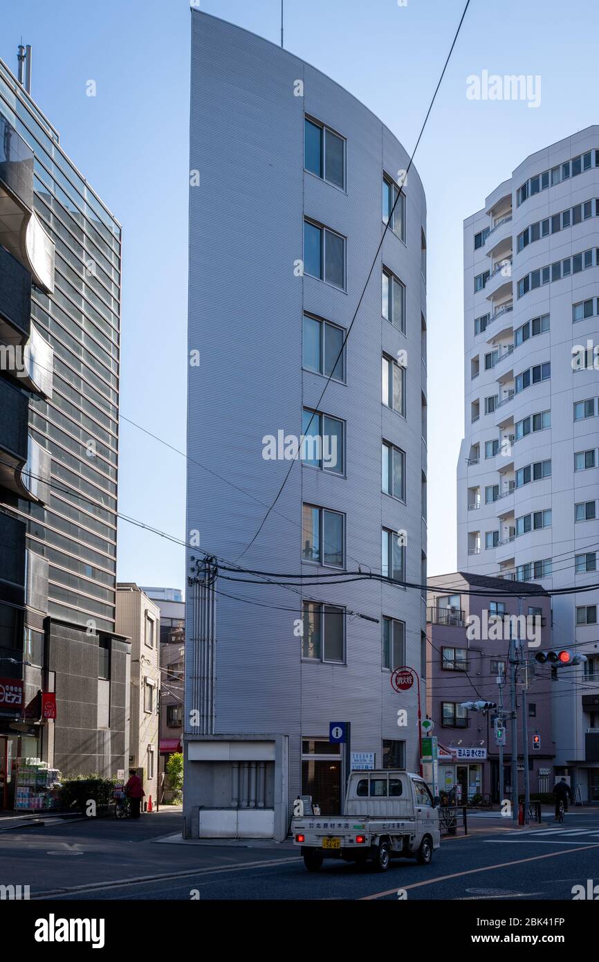 Piccolo edificio moderno spremuto in Street, Tokyo Foto Stock