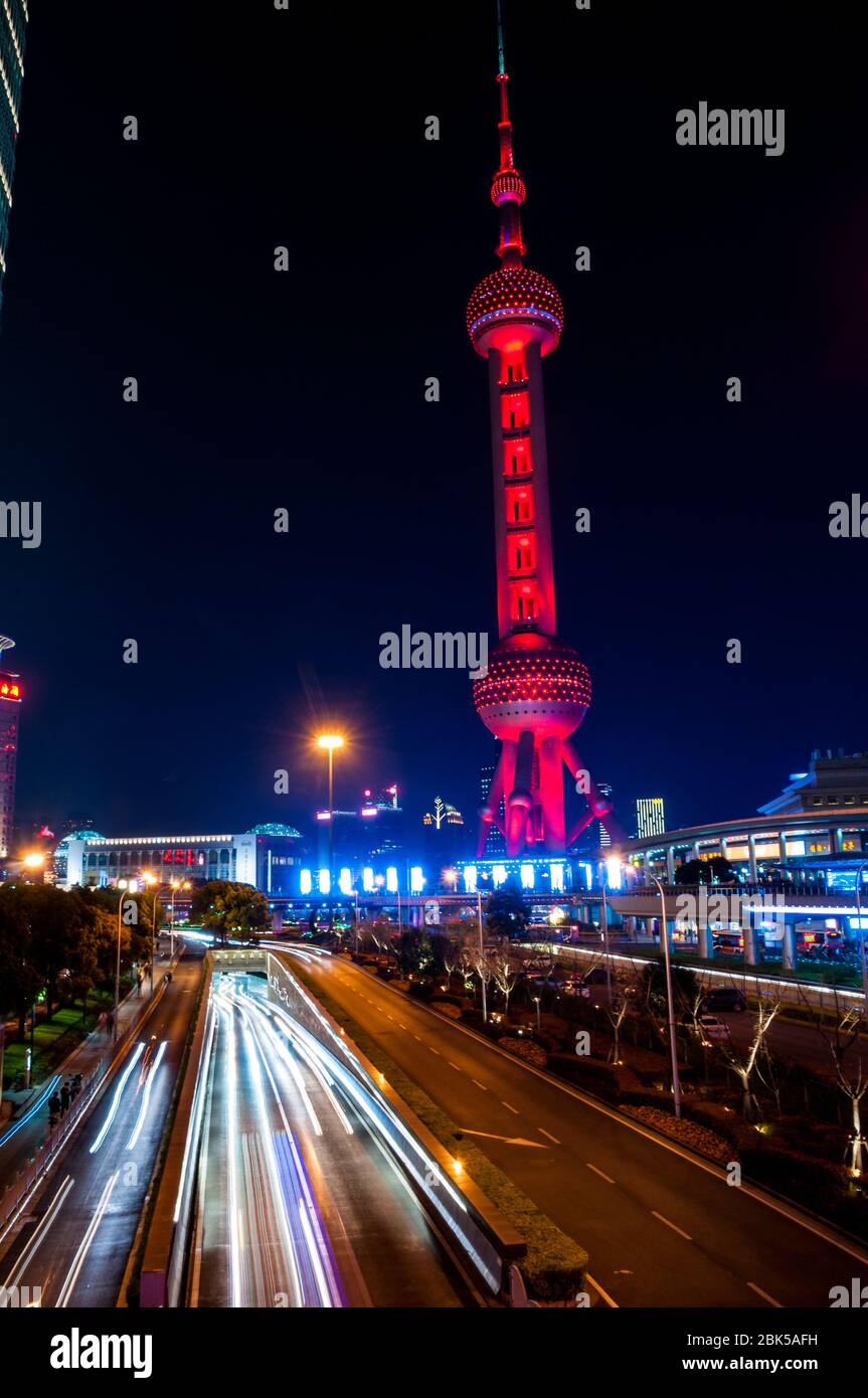 La Oriental Pearl Tower visto durante la notte con una luce percorsi dai veicoli emergente dal Yan'an Tunnel. Foto Stock