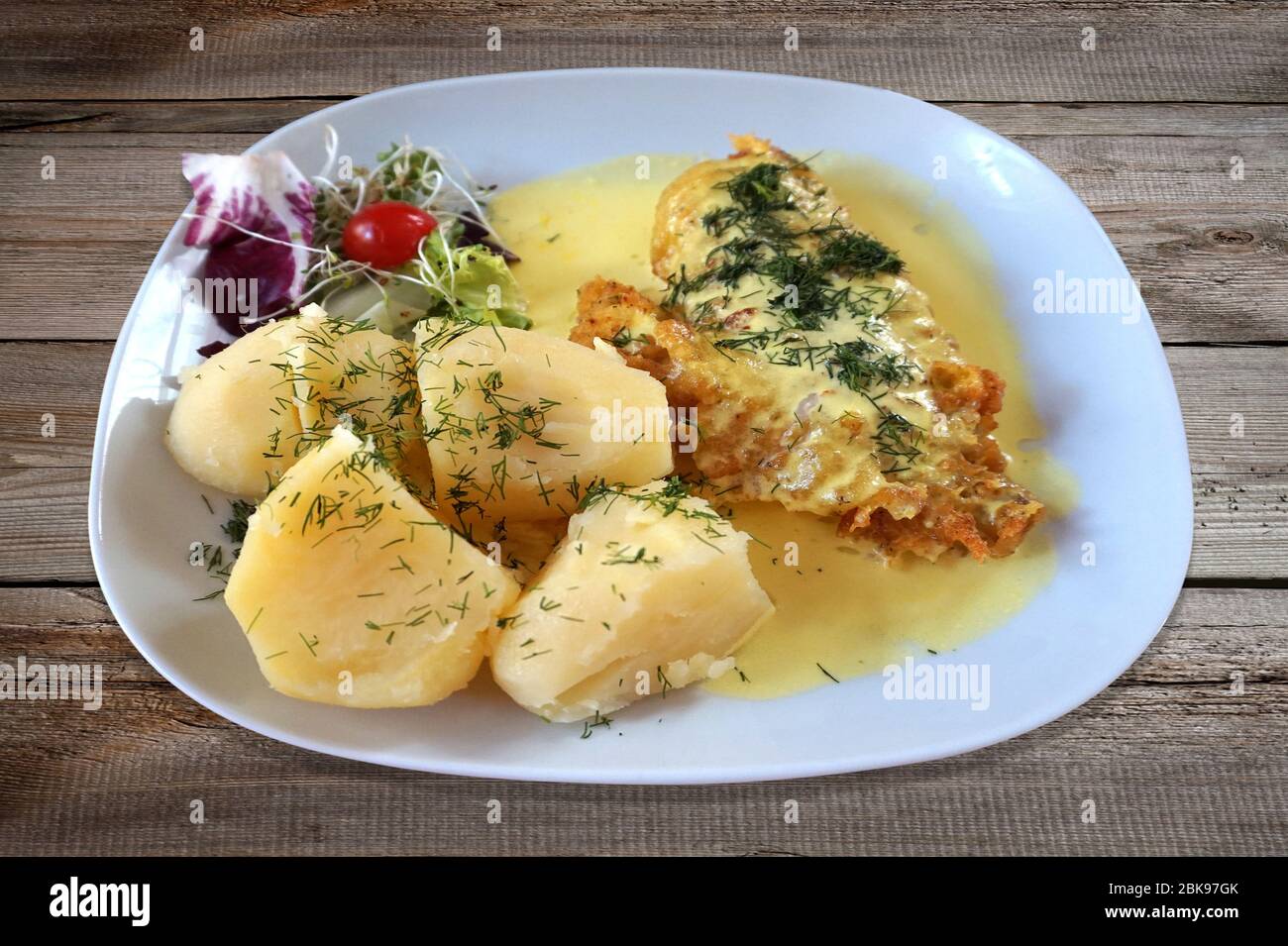 Pesce fritto - pesce rosa, insalata e patate sul piatto Foto Stock