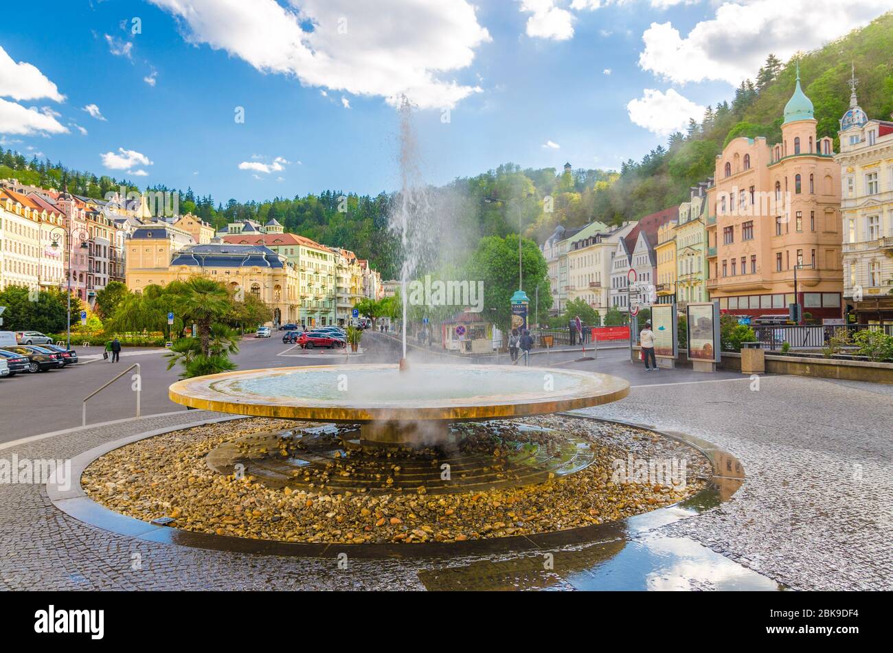 Karlovy Vary, Repubblica Ceca, 10 maggio 2019: Geyser sorgente termale Vridlo a Carlsbad centro storico della città, argine del fiume Tepla, colorati edifici belli, Boemia occidentale Foto Stock