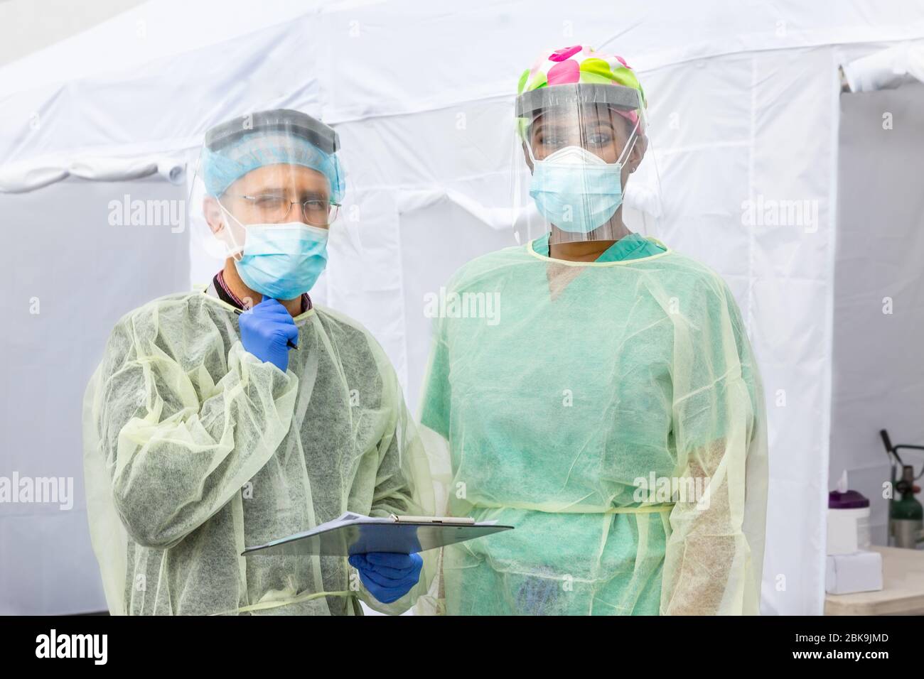 Gli operatori sanitari testano CoVid19 e discutono dell'antidoto e dei test in una tenda sterile a turni durante l'epidemia globale. Foto Stock