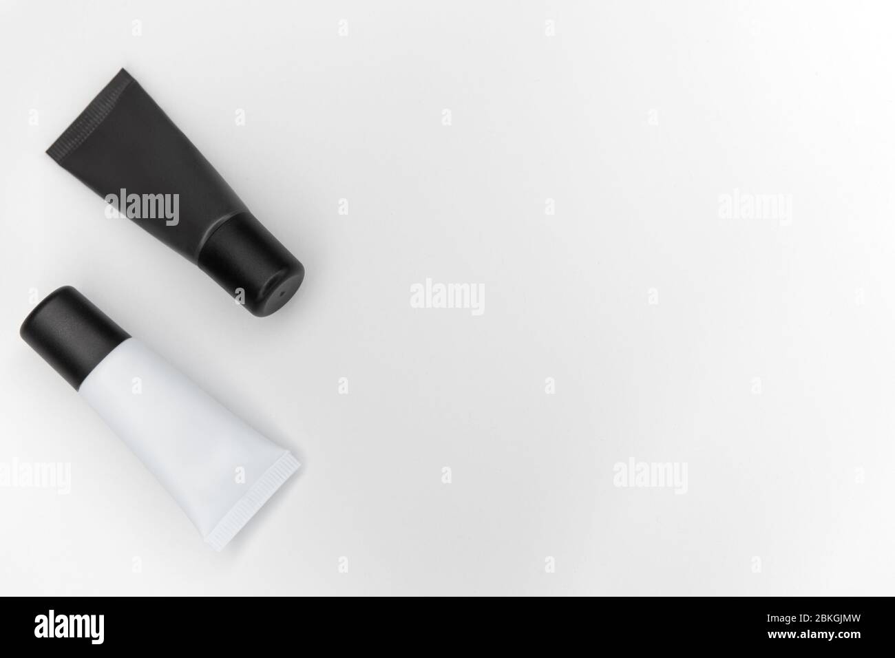 Tubi con cosmetici su fondo bianco. Foto Stock