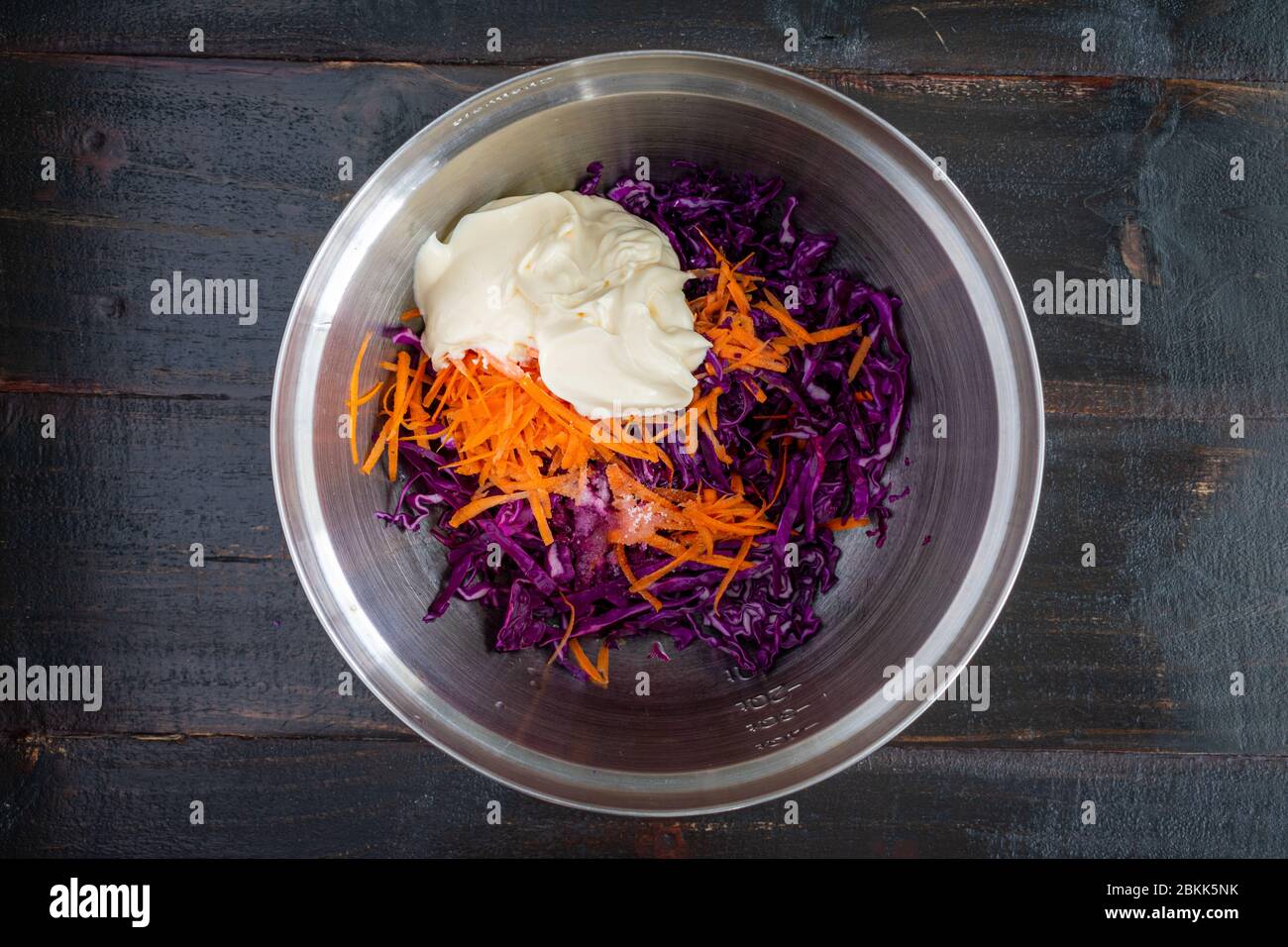 Ingredienti di coleslaw in una ciotola mescolante: Maionese, cavolo trito, carote e altri ingredienti di slaw Foto Stock